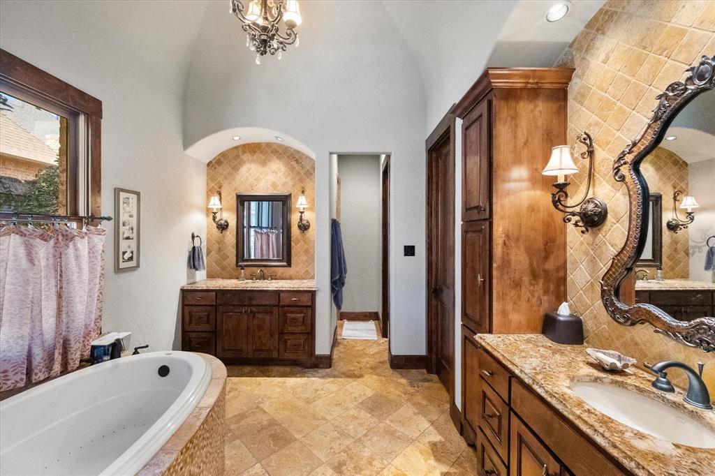 920 Nottingham Road Keller, TX 76248 - Photo 25 of 38 a spacious bathroom with a granite countertop tub sink a mirror and shower