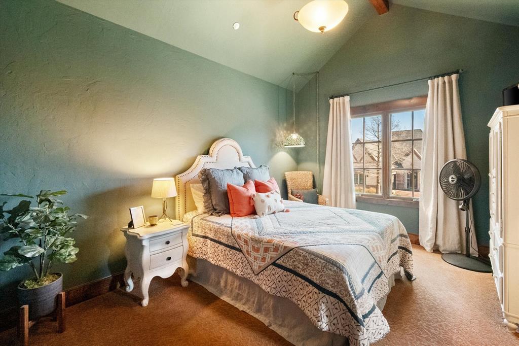 920 Nottingham Road Keller, TX 76248 - Photo 30 of 38 a bedroom with a bed and a chandelier