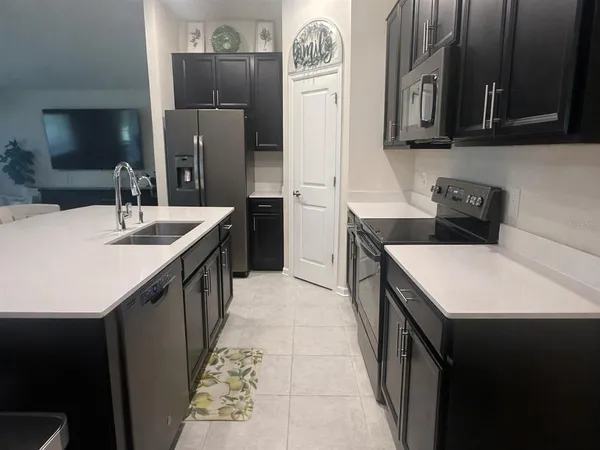 a kitchen that has a sink and a stove in it