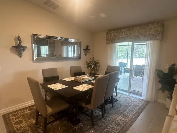 a view of a dining room with furniture window and outside view