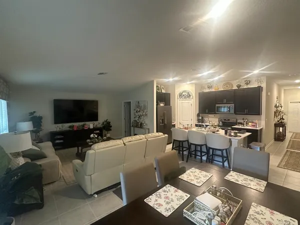 a living room with lots of furniture and a flat screen tv