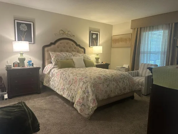 a bedroom with a bed and window