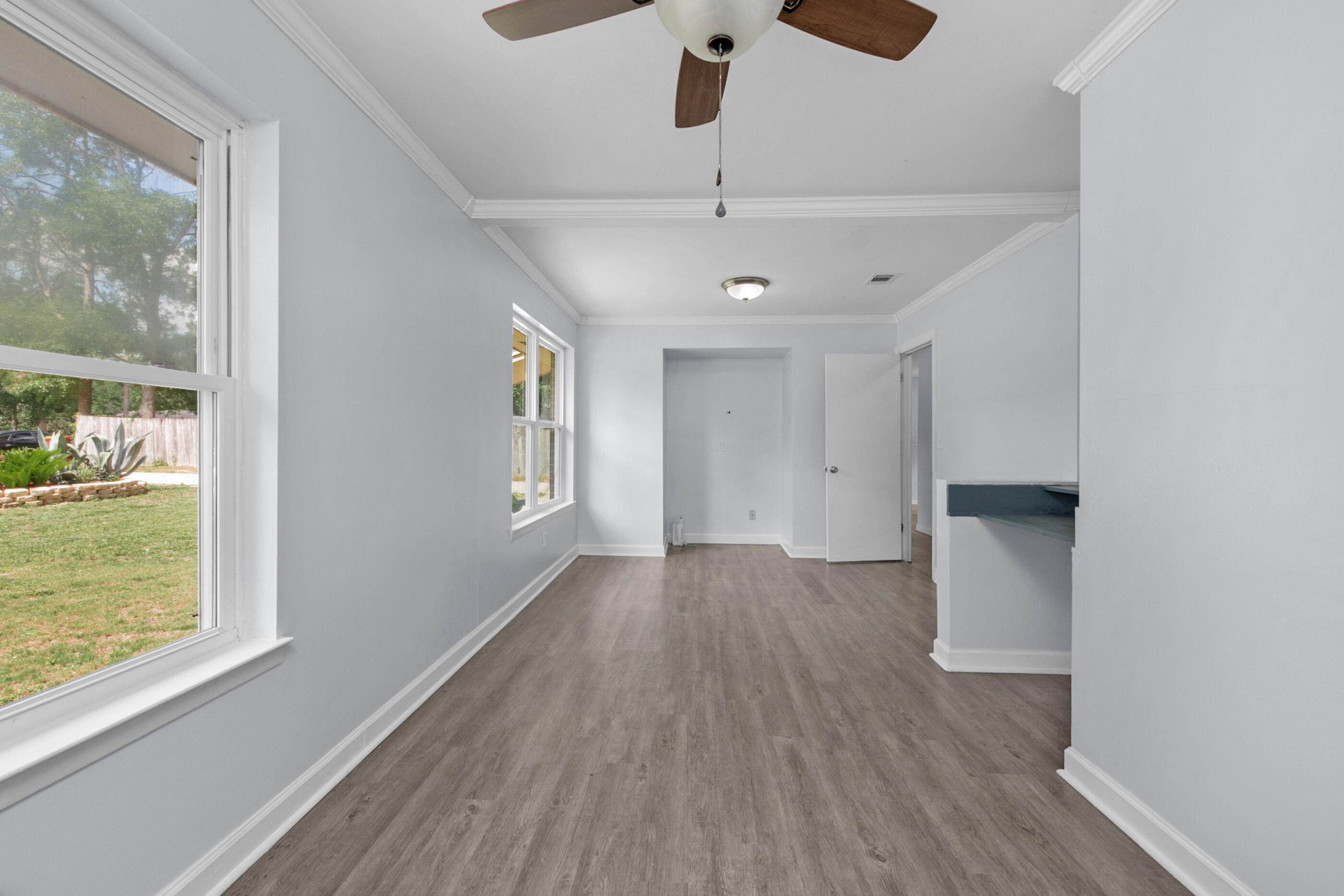 2909 Aplin Road Crestview, FL 32539 - Photo 19 of 29 a view of an empty room with wooden floor and a window