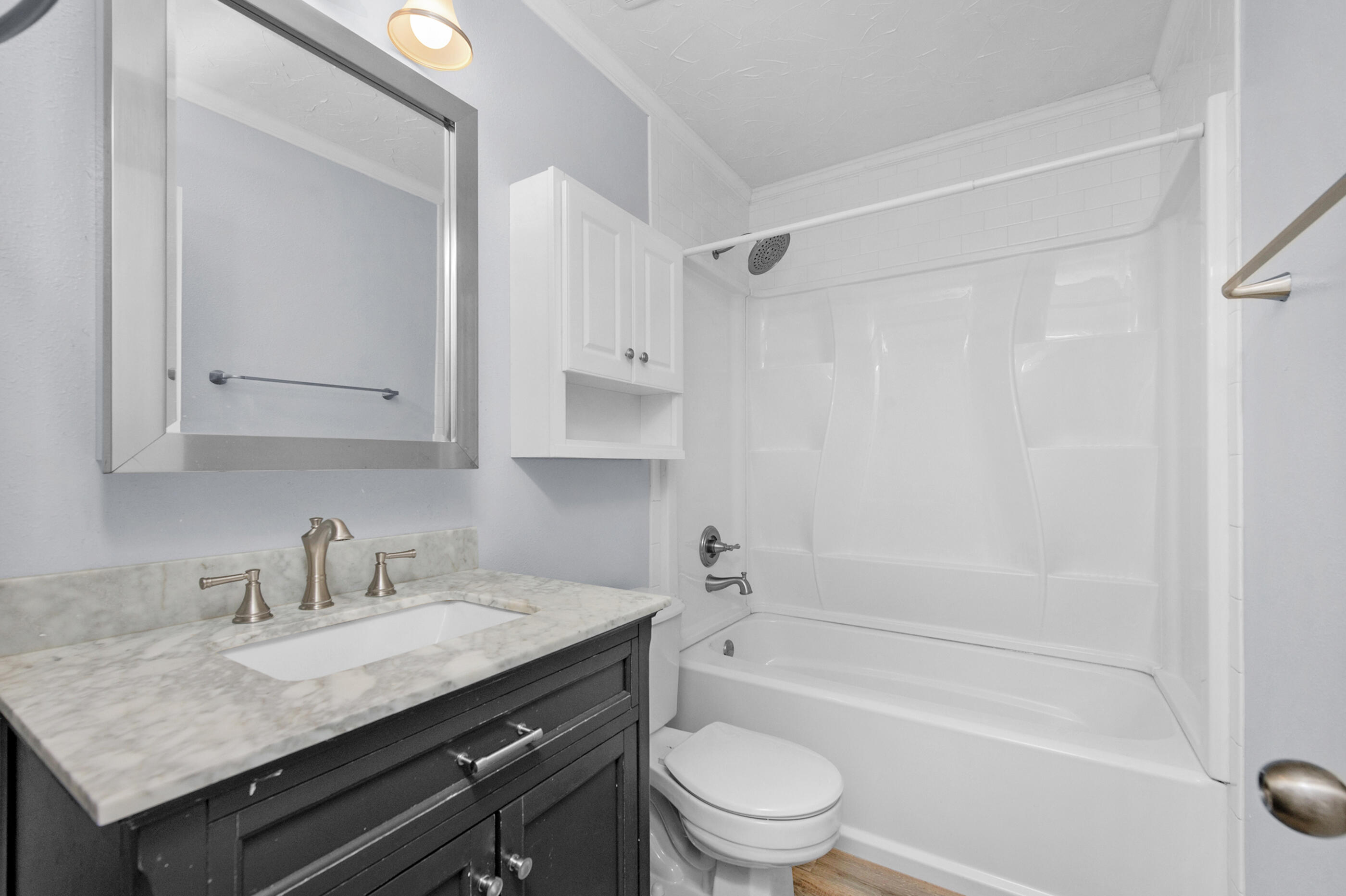 2909 Aplin Road Crestview, FL 32539 - Photo 20 of 29 a bathroom with a granite countertop sink toilet and shower