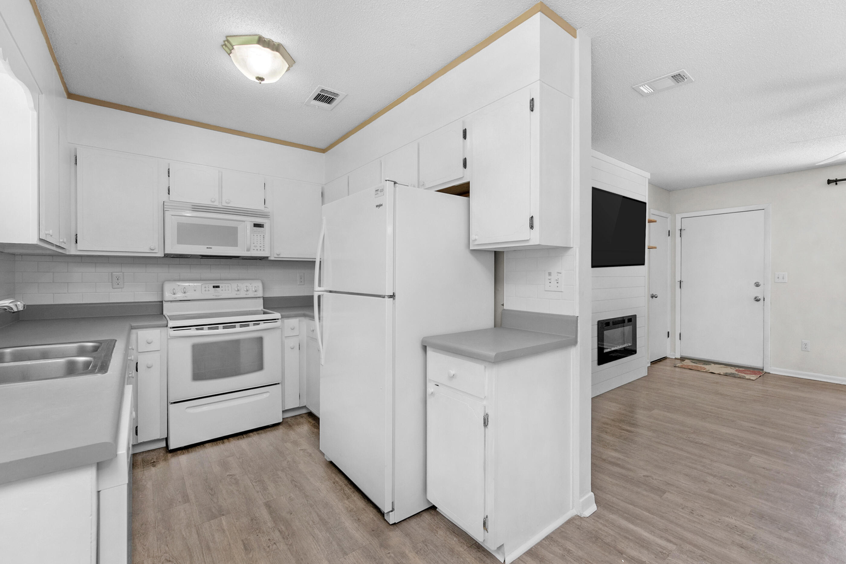 2909 Aplin Road Crestview, FL 32539 - Photo 8 of 29 a kitchen with stainless steel appliances white cabinets and a stove