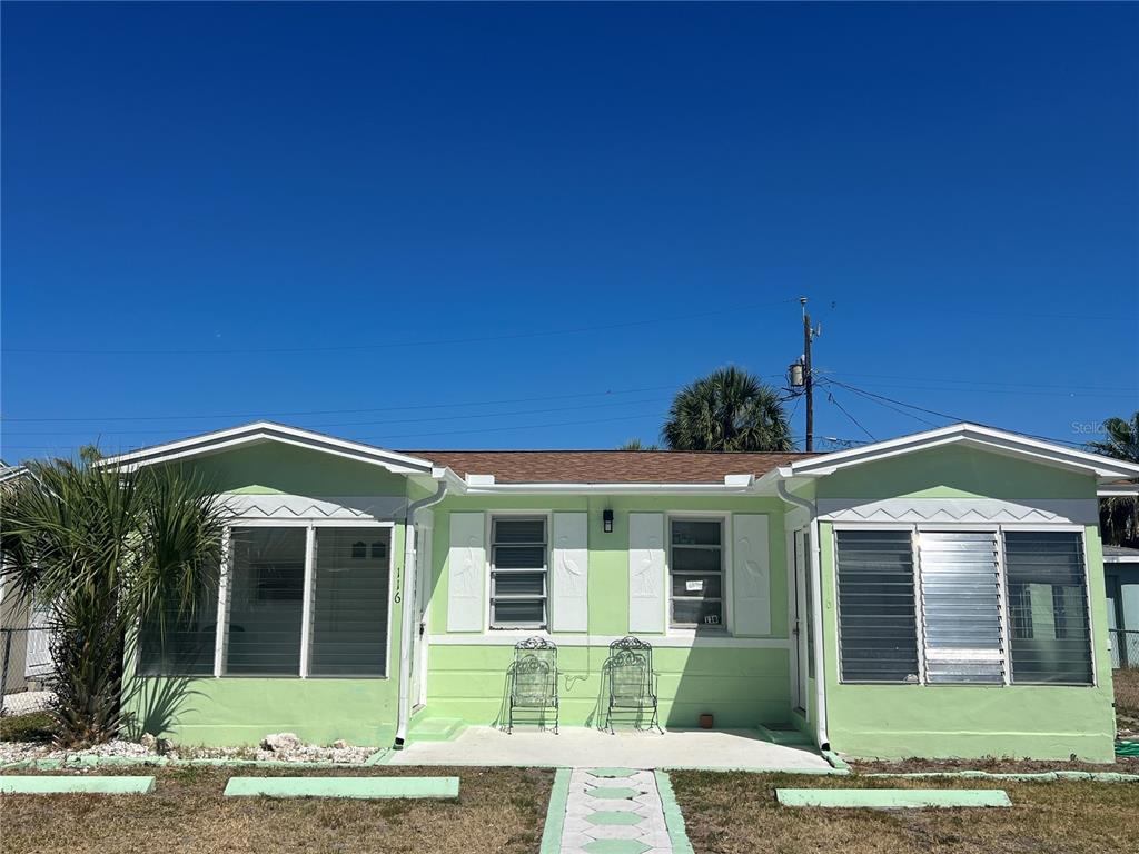 116 145th Avenue Madeira Beach, FL 33708 - Photo 3 of 17 a front view of a house with garden