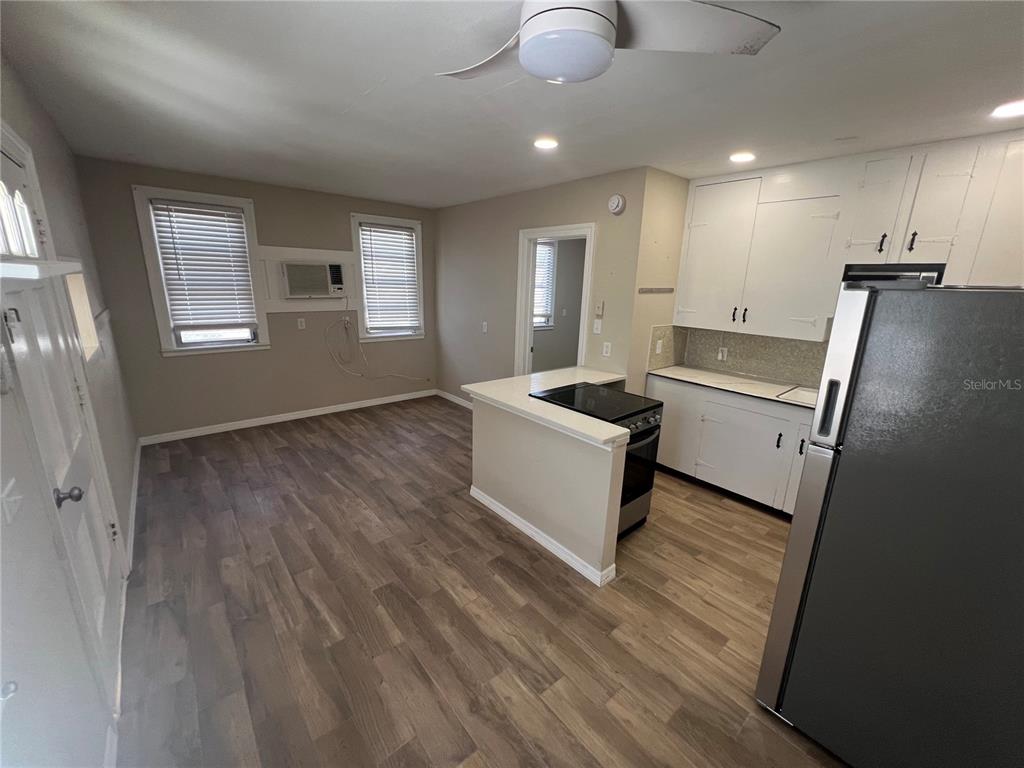 116 145th Avenue Madeira Beach, FL 33708 - Photo 5 of 17 a view of a livingroom with furniture wooden floor and windows