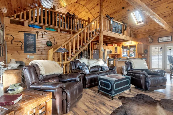 a view of a patio with couches fire pit and a barbeque grill with couches