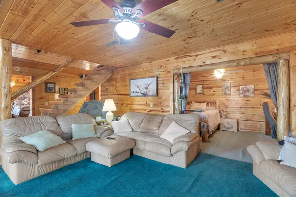a living room with furniture and a chandelier