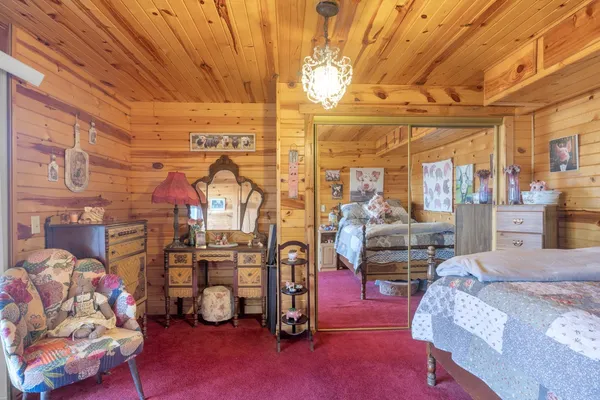 a bedroom with furniture and a flat screen tv