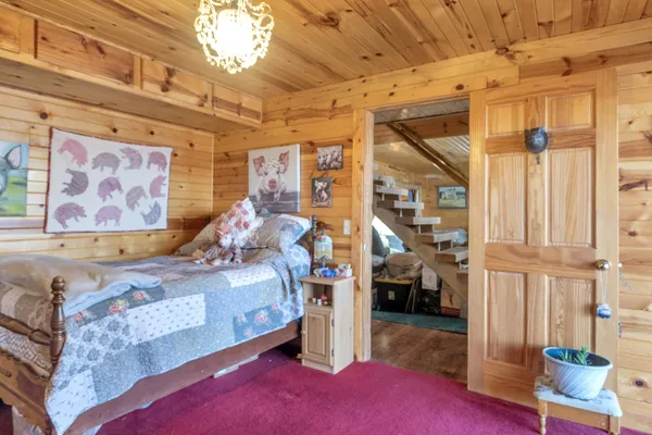 a bedroom with bed and a window