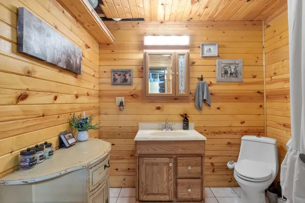 a bathroom with a sink toilet and mirror