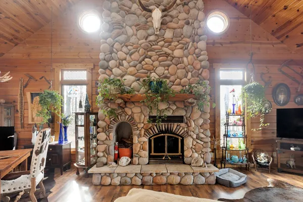 a living room with furniture a flat screen tv and a fireplace