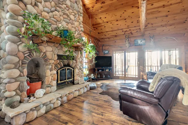 a living room with furniture a fireplace and a flat screen tv