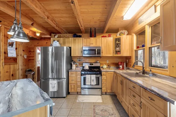 a kitchen with stainless steel appliances granite countertop a refrigerator and a sink