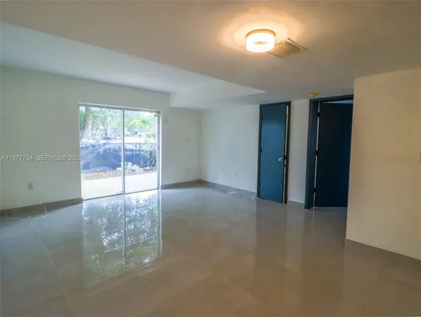 a kitchen with white cabinets and appliances