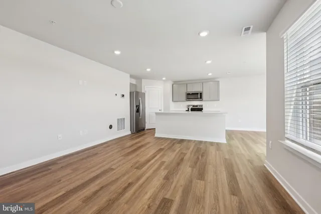 a view of a kitchen with a sink and wooden floor