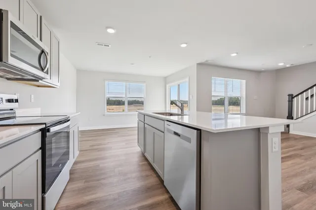 a kitchen with counter top space and wooden floor