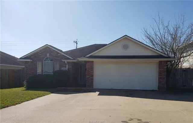 a front view of house with yard and trees