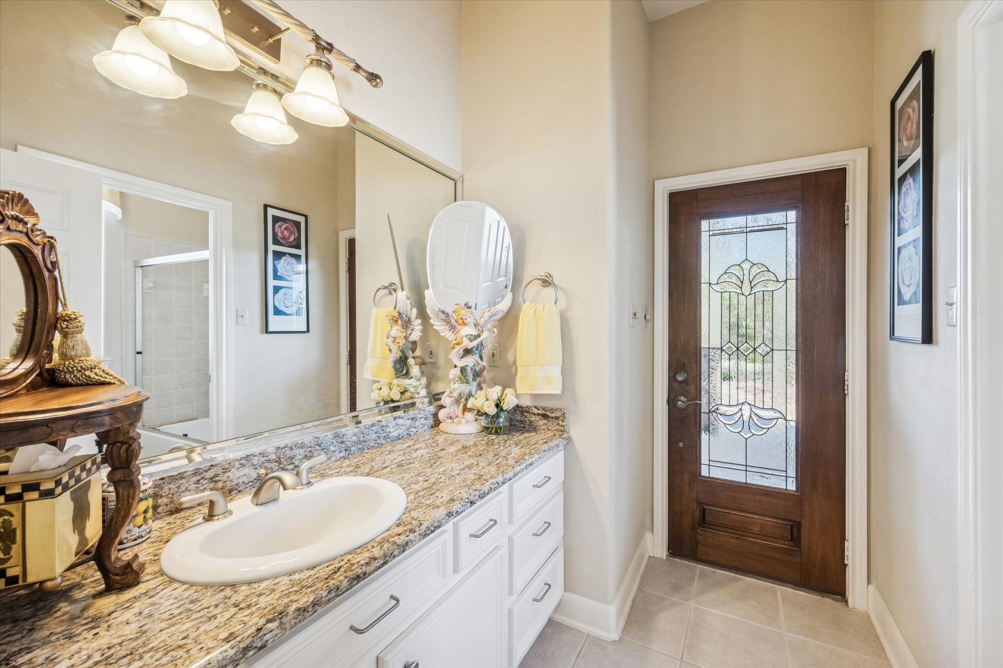 16372 Highway 6 Navasota, TX 77868 - Photo 27 of 49 a en suite bathroom with a granite countertop sink and a mirror