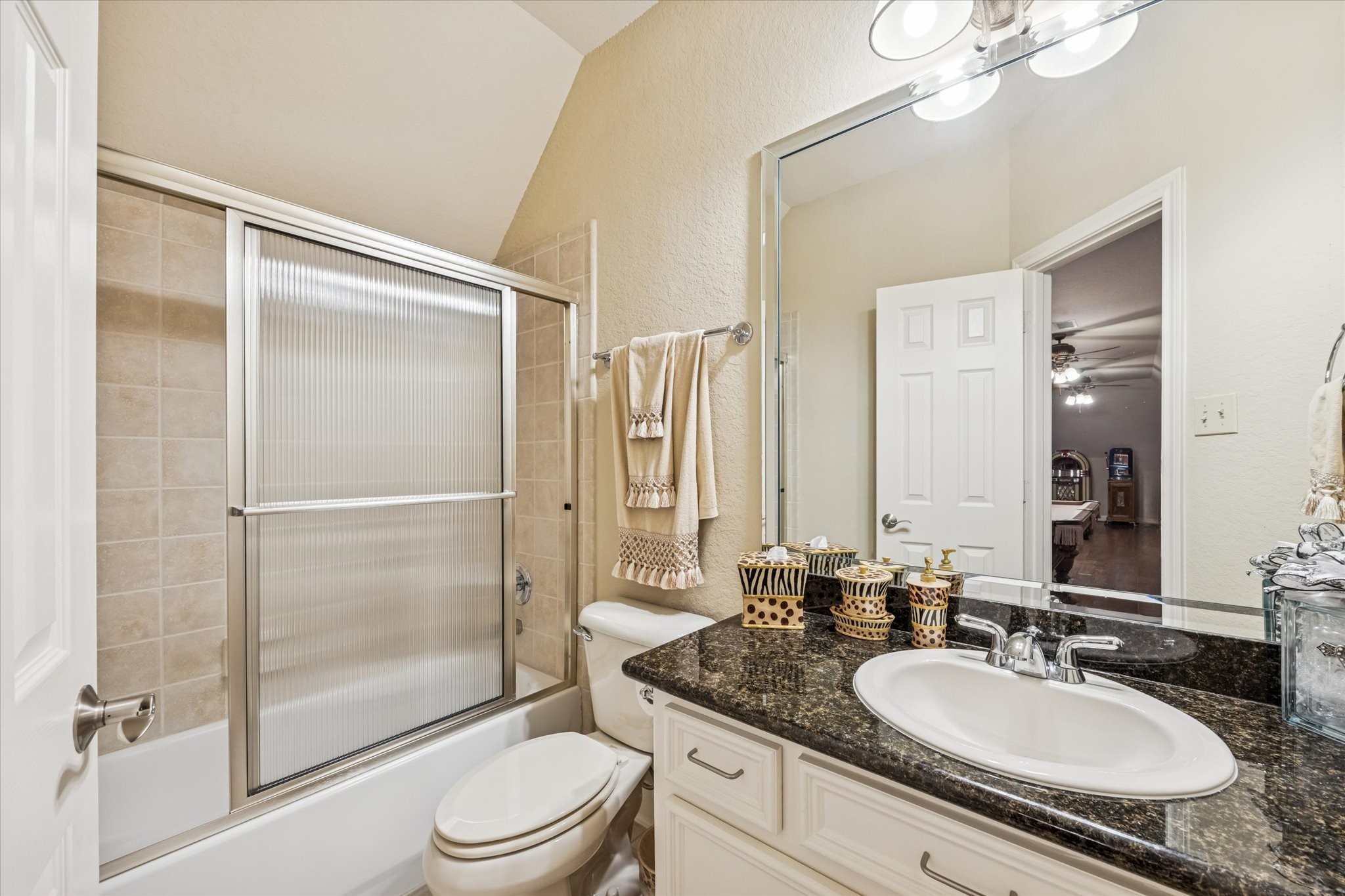 16372 Highway 6 Navasota, TX 77868 - Photo 29 of 49 a bathroom with a granite countertop sink toilet a mirror and shower