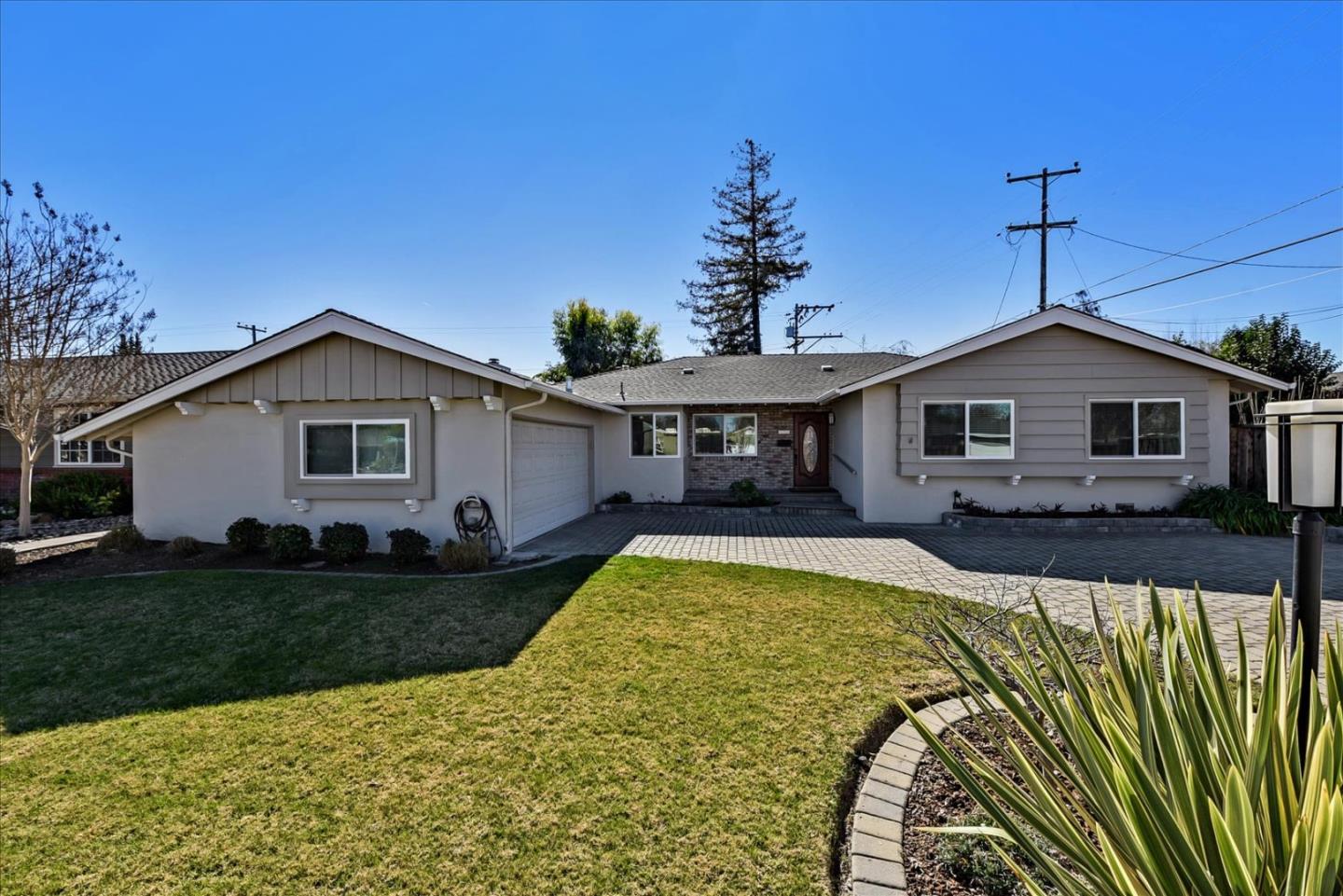 a view of a house with swimming pool and a yard