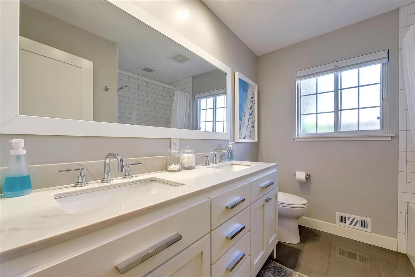 1712 St Anthony Drive San Jose, CA 95125 - Photo 35 of 47 a bathroom with a granite countertop toilet a sink and a mirror
