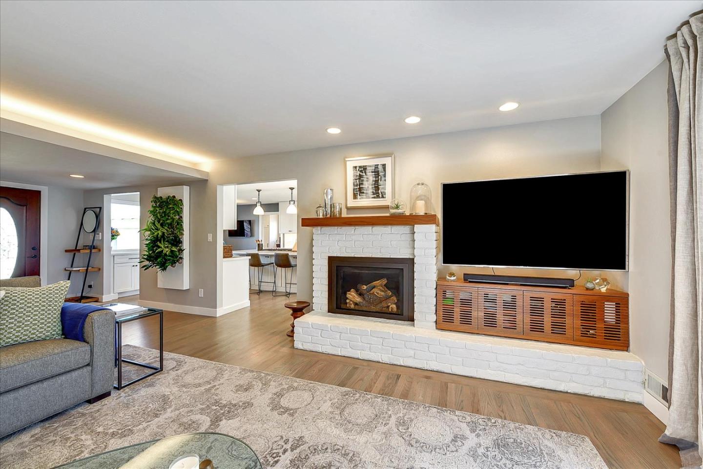 1712 St Anthony Drive San Jose, CA 95125 - Photo 7 of 47 a living room with furniture a flat screen tv and a fireplace