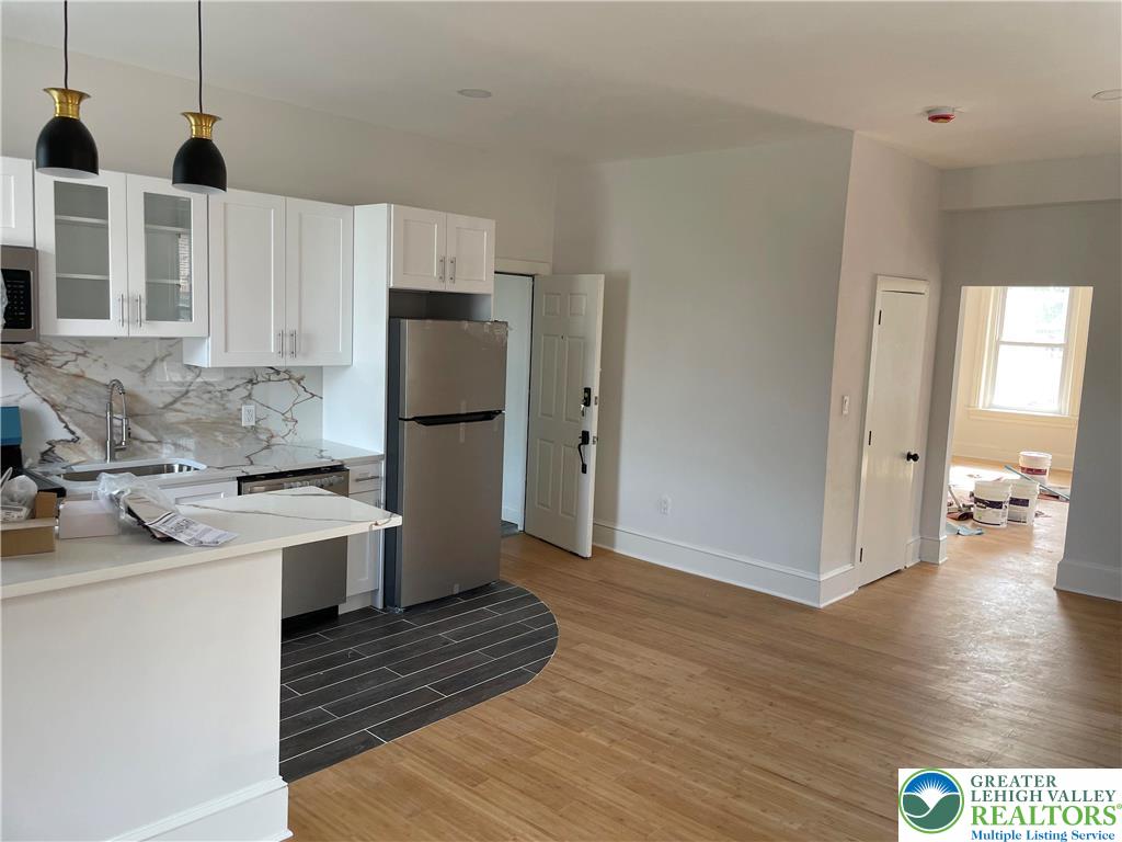 701 Main Street, Unit 2 Slatington, PA 18080 - Photo 3 of 11 a kitchen with stainless steel appliances granite countertop a refrigerator a stove and a wooden floors