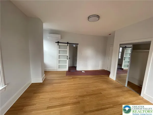 a view of an empty room and wooden floor