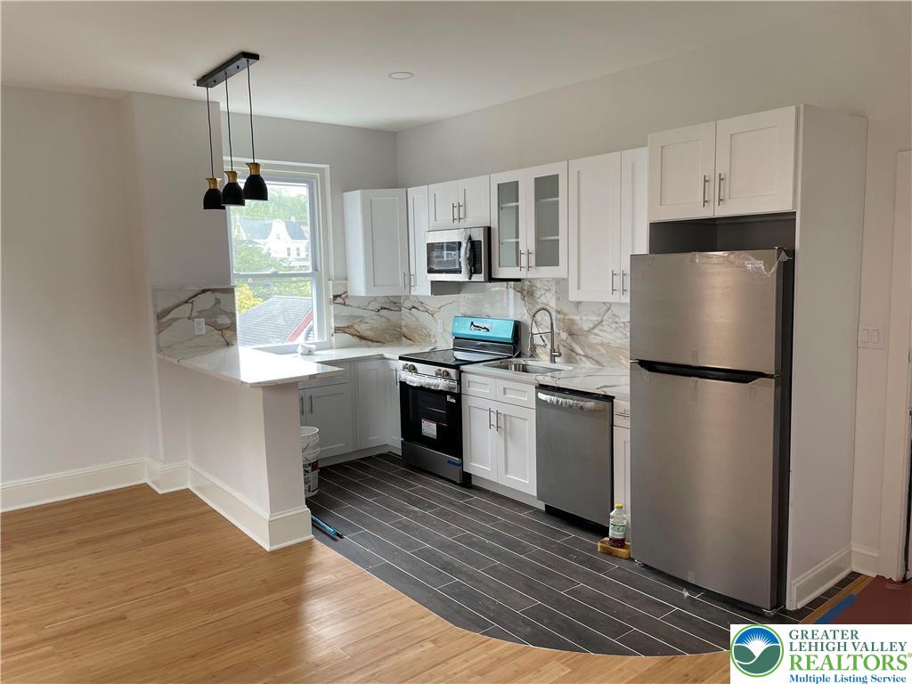 701 Main Street, Unit 2 Slatington, PA 18080 - Photo 10 of 11 a kitchen with a refrigerator sink and cabinets