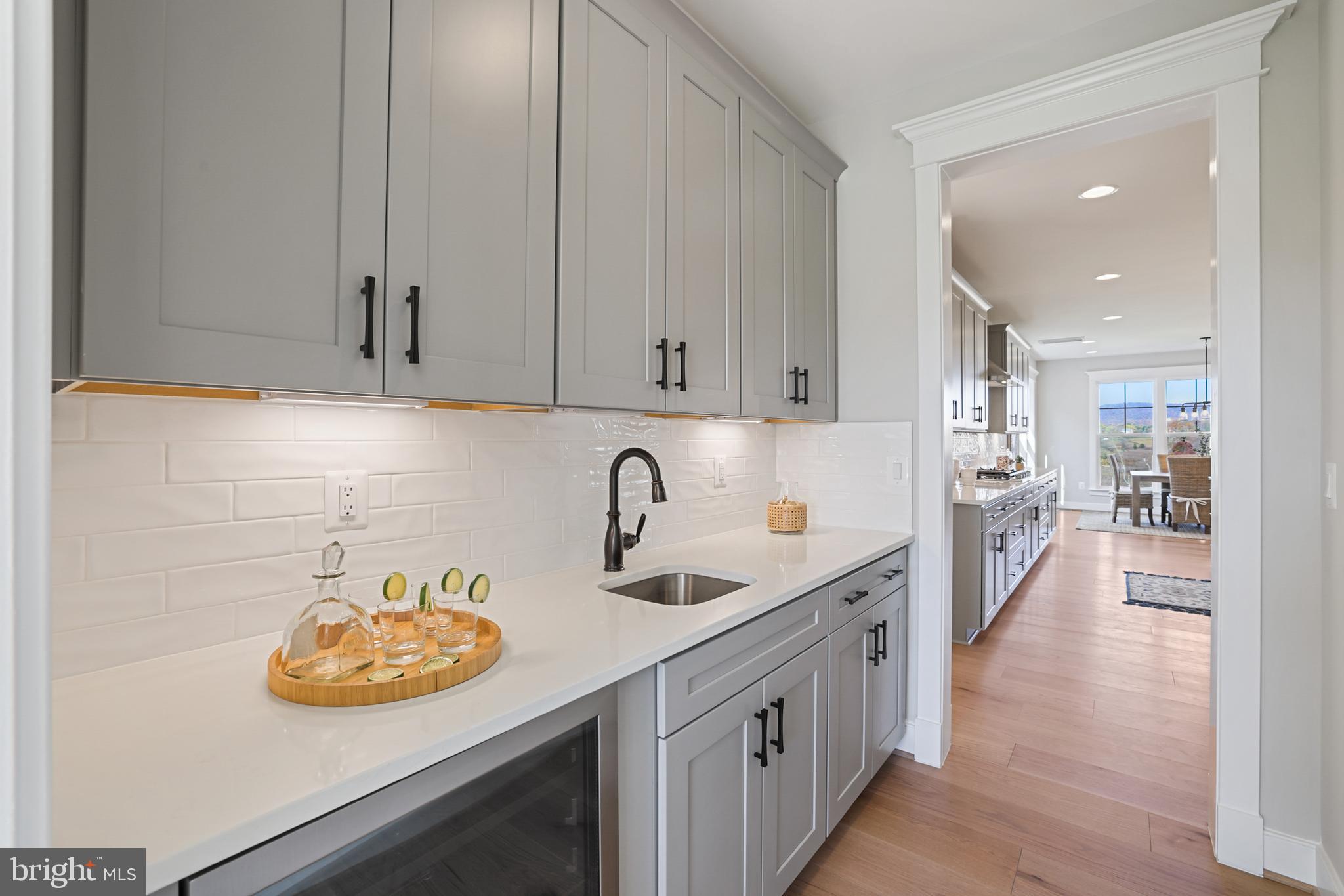 17628 Bates Drive Hamilton, VA 20158 - Photo 28 of 57 a kitchen with kitchen island white cabinets and sink