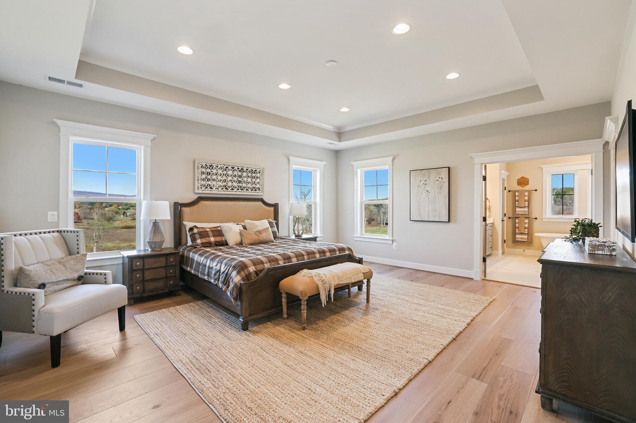 17628 Bates Drive Hamilton, VA 20158 - Photo 41 of 57 a spacious bedroom with a bed a table and couch