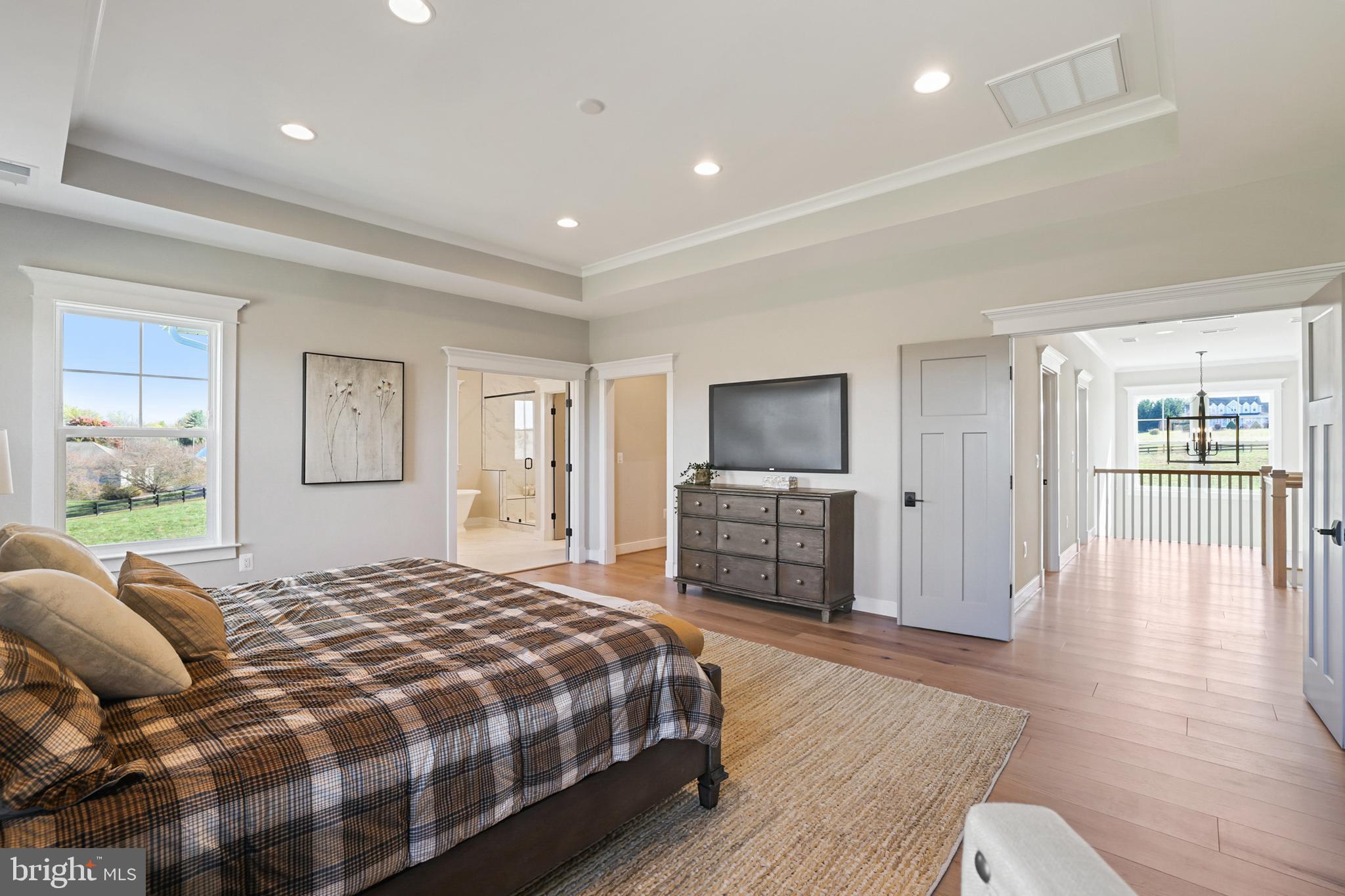 17628 Bates Drive Hamilton, VA 20158 - Photo 42 of 57 a spacious bedroom with a bed and wooden floor