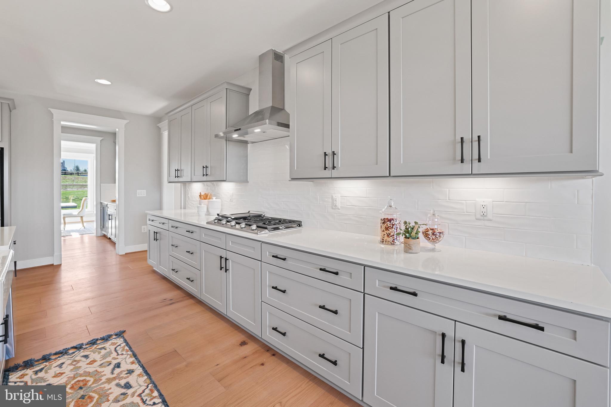 17628 Bates Drive Hamilton, VA 20158 - Photo 6 of 57 a kitchen with granite countertop white cabinets and stainless steel appliances
