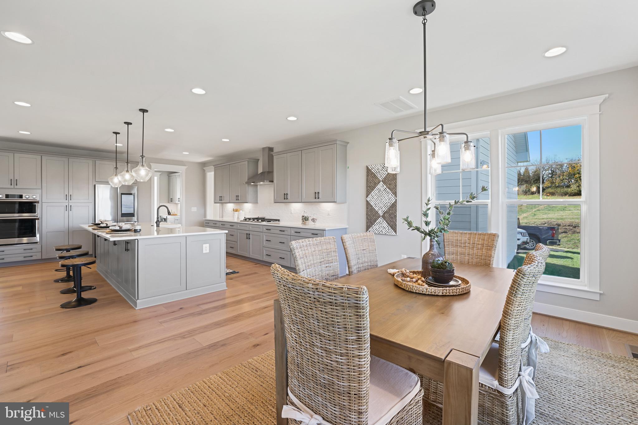 17628 Bates Drive Hamilton, VA 20158 - Photo 9 of 57 a kitchen with a table chairs and white cabinets