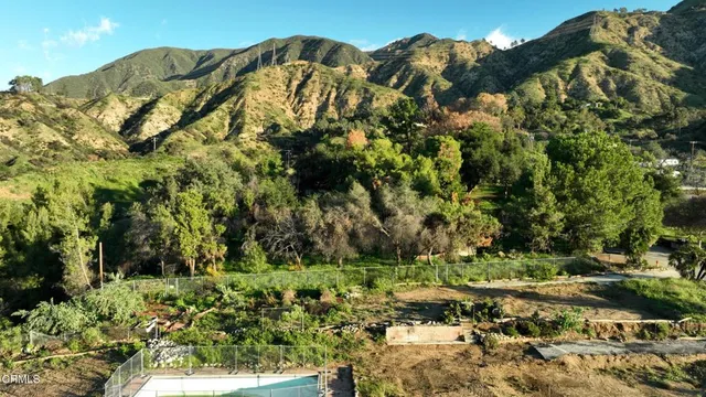 a view of a large building with a yard and mountain view
