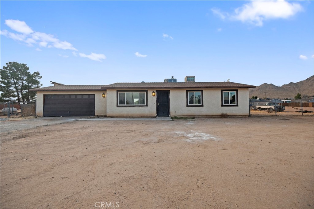 15856 Winnebago Road Apple Valley, CA 92307 - Photo 1 of 1 a view of a house with a garden and pathway