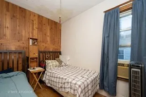 a bedroom with a bed and a table in it