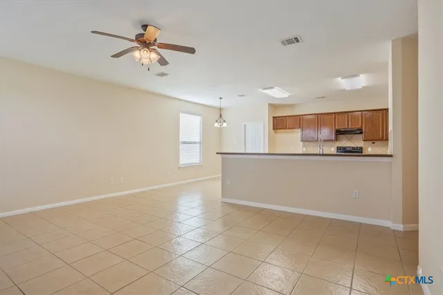 a view of a kitchen with marble kitchen and stainless steel appliances