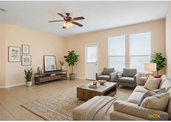 an empty room with a window and a fan