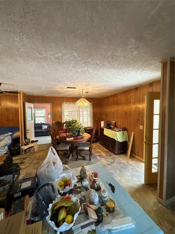 a living room with furniture a chandelier and a large window