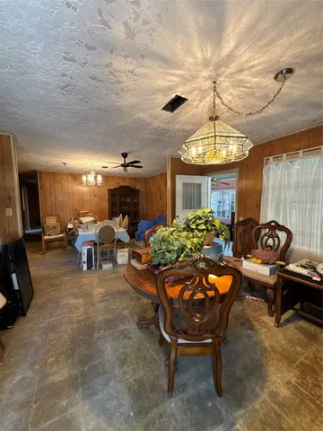 a living room with furniture a dining table and a piano