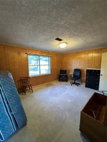 a living room with a window and a dresser