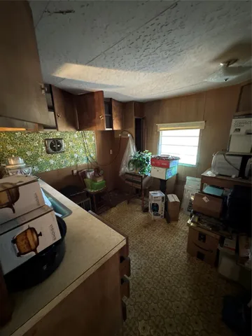 a view of a room with wooden ceiling