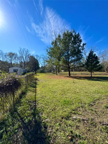 a view of a yard with table and chairs