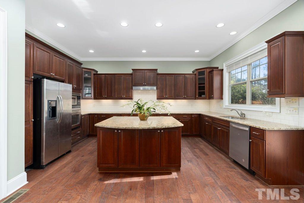 3322 Roller Mill Court Raleigh, NC 27607 - Photo 12 of 30 Oversized gourmet island w/granite counter tops/lots of cabinetry/ss appliances/walk-in pantry