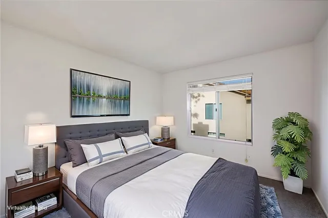 a bedroom with a bed and a painting on the wall