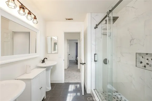 a bathroom with a sink a toilet and shower