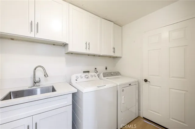 a view of storage and utility room with washer and dryer